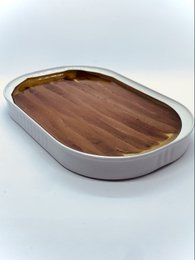 Canned anchovies from the Cantabric Sea, spring season catch. Oval-shaped tin container with wooden lid.