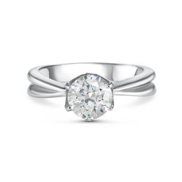 Devotion Ring - Elegant solitaire diamond engagement ring with split shank design in platinum.
The Devotion Ring is an elegant solitaire diamond engagement ring with a split shank design crafted in platinum. The round brilliant-cut diamond is the focal point, set in a classic six-prong setting. The split shank design adds a modern touch, creating a visually appealing and sophisticated look. This ring is available in various European and US sizes to ensure a perfect fit.