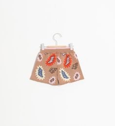 Beige kids shorts with colorful butterfly and leaf print. Made of lightweight, breathable fabric. Suitable for ages 2-10 years.