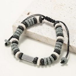 Flat bead bracelets in natural lava stone dyed gray, black, and white. Adjustable braided cord bracelet with natural stone beads.
