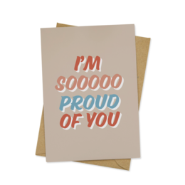 A greeting card with the text "I'm so proud of you" in colorful lettering on a beige background.