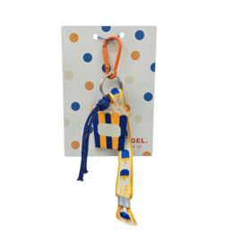 Colorful popcorn-themed keychain with orange, yellow, and navy blue stripes, polka dot pattern, playful design.