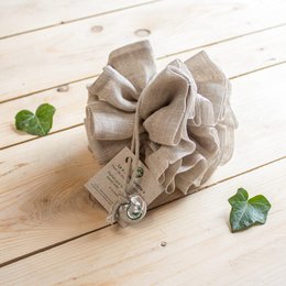 Linen shower flower sponge in a natural, beige color with a ruffled, floral design. Made of soft, absorbent linen material.