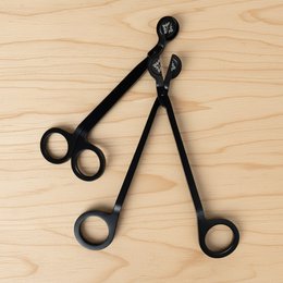 Black metal wick trimmer scissors with round handles, stylish candle care tool, elegant design.