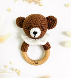  Handmade crochet baby rattle in the shape of a bear, koala, fox, penguin, or reindeer. Made with soft, natural materials and featuring a wooden teething ring.