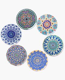 Decorative coasters featuring intricate mandala patterns in shades of blue, green, and purple. The coasters have a boho-inspired design and appear to be made of ceramic or porcelain material.