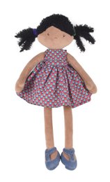 A 42cm tall doll with dark hair in a purple and white polka dot dress, blue shoes, and a pink bow.