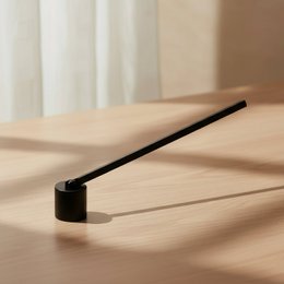 Black candle snuffer with long handle, minimalist design, metal tool for candle care