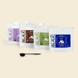 Premium instant coffee starter set with classic and decaf variants, featuring bags of ground coffee in various flavors.