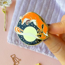 Gold plated hard enamel pin with a cat astronaut design. Suitable for wearing as a brooch.
