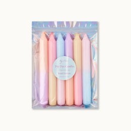 Set of 8 pastel-colored dip-dyed dinner candles in a variety of soft, muted shades including pink, lavender, and blue.