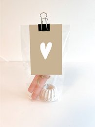Elegant heart-shaped candle holder with a pink candle. Crafted from high-quality materials, perfect for adding a touch of romance to any dinner setting.