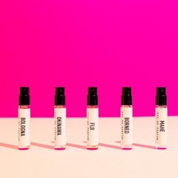 Floral eau de parfum set with 5 small bottles in a pink and white color scheme. The bottles are labeled "Sober" and appear to contain a floral-scented perfume.