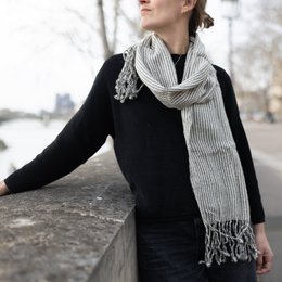  Soft, cozy striped scarf in gray and white or coffee and white colors. Versatile accessory with fringe detail.