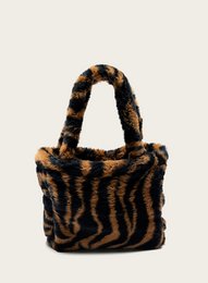 Zebra-patterned mini shoulder bag with a plush, furry texture and a structured silhouette.