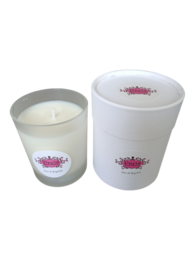 A tall, round white candle with a pink floral design on the label. The candle is made of cotton and has a weight of 140 g.