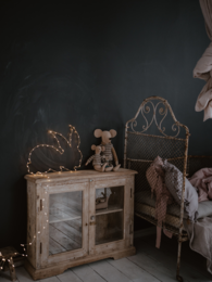Whimsical rabbit-themed lamp with glass cabinet, perfect for a child's bedroom. Features warm lighting, rustic wooden frame, and decorative rabbit figurine.