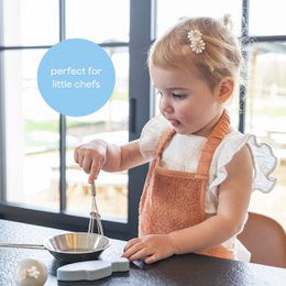 Apron for little artists, made of cotton, available in various colors including Marin, Misty Rose, Frosted Almond, Whisper Green, Moon Blue, Daisy White, Feather Grey, Savannah Sand, Riviera Blue, Jungle Green, and Sunrise Orange. The apron features a simple, classic design that is perfect for protecting children's clothing while they engage in creative activities.