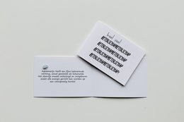 A white greeting card with a handwritten message that says "Get well soon!" The card is placed on a light gray background.