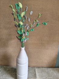 "Artificial flower stems, green and purple blooms, decorative botanical arrangement, dried flower stems"