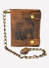Vintage leather wallet with embossed Native American design, featuring a chain strap and snap closure. Dimensions approximately 4" x 5".