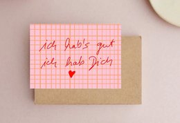 A colorful postcard with the German text "Machs lieber richtig, als nie!" which translates to "It's better to do it right than never." The postcard has a pink and yellow striped background.
