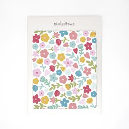 Colorful floral pattern wallpaper for kids' room. Features a variety of small flowers in pink, blue, yellow, and other pastel shades.