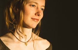 Minimalist brass drop charm necklace with adjustable leather cord. Available in small, medium, and large sizes.