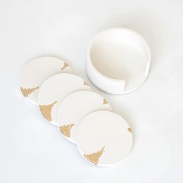 Set of 4 round white and gold drink coasters with a holder.