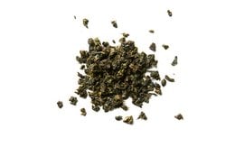 Loose leaf green tea with 13 different flavors, packaged in a tin container with a decorative pattern.