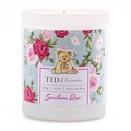 A round, tall scented candle with a floral design featuring pink and red roses, and a teddy bear image. The candle is labeled "Sevillana Rose" and has a 220g weight.