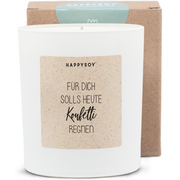 A round, tall white candle with a simple label that says "Fur dich sollst heute konfetti regnen" (For you, confetti should rain today).