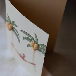 Colorful birthday card with tropical palm tree design and wooden beads.
