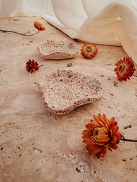  Beige organic dish with terracotta speckles, heart-shaped, natural earthy aesthetic, decorative tray.