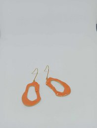 Peach-colored enamel drop earrings with a unique organic shape.