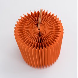 Concertina paper stool in orange color, available in two sizes: 30⌀ x 38cm H and 30⌀ x 28cm H. Cylindrical shape with vertical pleated design.