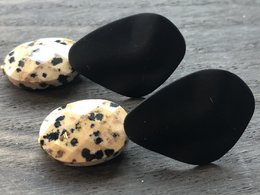 Black drop earrings with spotted pattern.