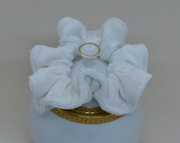 White scrunchie hair accessory, soft and fluffy texture.