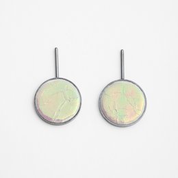 Iridescent white drop earrings with a minimalist, circular design.