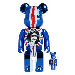 Colorful, stylized figurine with large ears, sunglasses, and dollar sign motif. Made of plastic materials in a modern, abstract design.