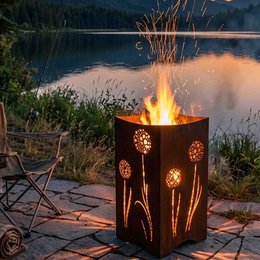 Rustic metal fire pit with dandelion motif, suitable for garden and terrace use.