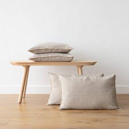 Linen cushion cover in natural terra color with fringe detail. Available in various sizes including 40 x 60 cm, 50 x 50 cm, and 30 x 40 cm.