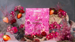  Pink sparkly chocolate bar with red berries, 49% dark chocolate, festive glitter packaging design.
