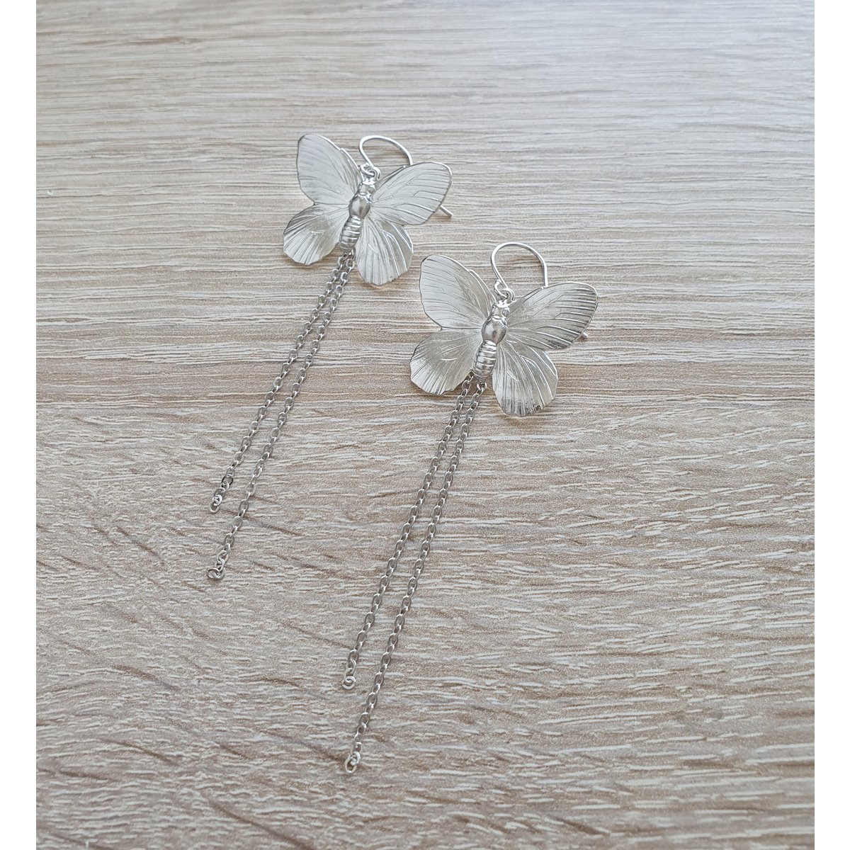 Long-length rhodium plated butterfly earrings