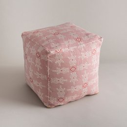 A square-shaped pink pouf with a geometric pattern featuring diamond shapes and other abstract designs. The pouf appears to be made of a soft, textured fabric.