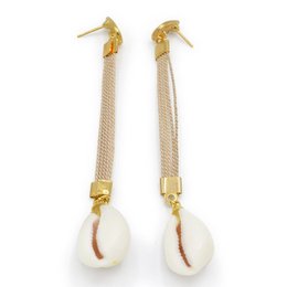 Gold-toned hoop earrings with dangling white shells and beaded chains.