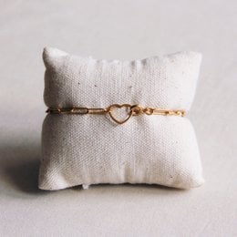 Gold-tone charm bracelet with open heart lock. Delicate chain links with a heart-shaped clasp.