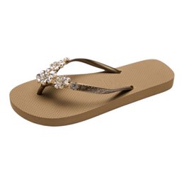  Women's flip flops with embellished straps, available in multiple colors including red, white, brown, black, grey, olive, taupe.