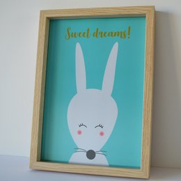 Framed poster with a cute, minimalist illustration of a white rabbit with the text "Sweet dreams!" in a turquoise background.