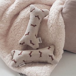 Plush bone-shaped Dachshund dog toy in a camouflage pattern, suitable for pet play and entertainment.